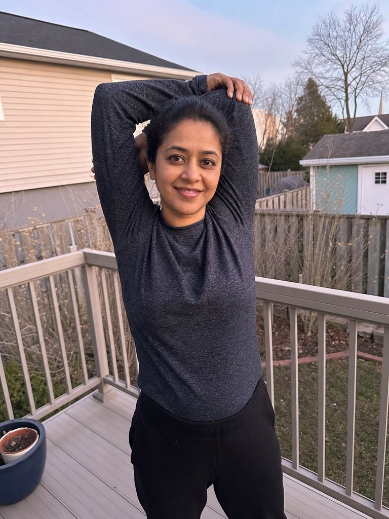 Woman stretching happily at sunset